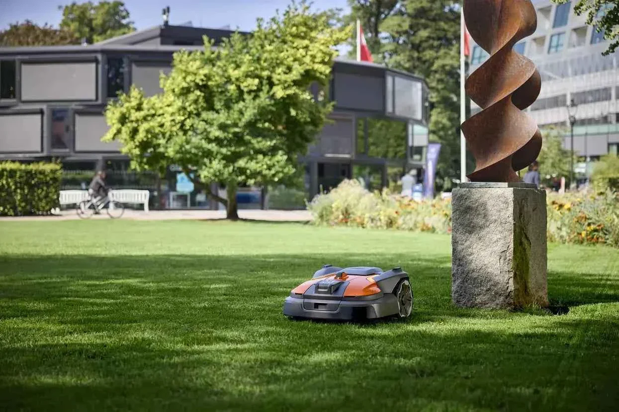Autonomous mower maintaining a manicured public park lawn